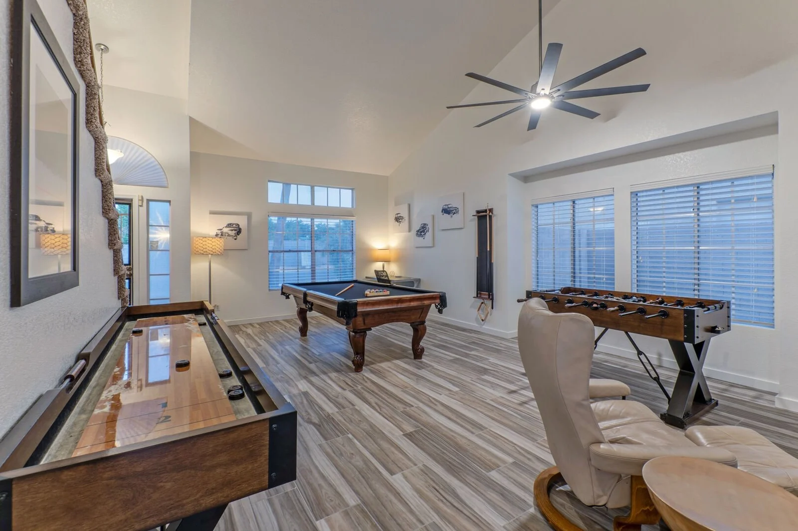 Game room with pool table, shuffleboard, and foosball